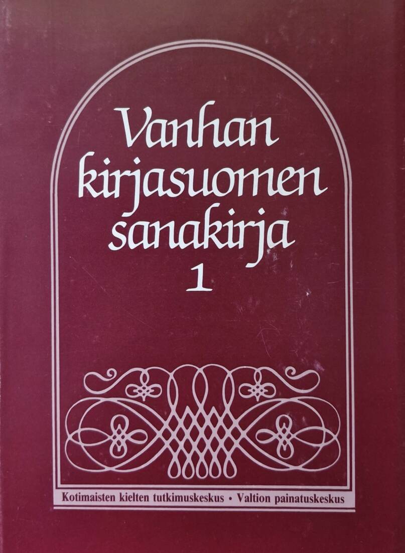 Tummanpunainen sanakirjan kansipaperi, jossa valkoinen teksti ja koristekiehkura.